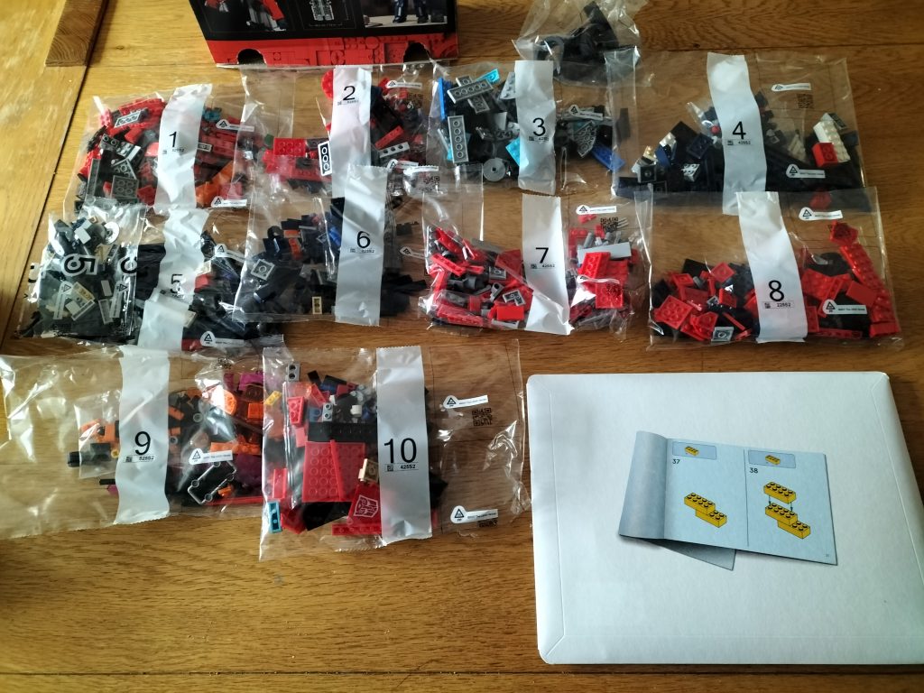 11 bags of the LEGO Optimus Prime set 10302, plus a cardboard envelope containing instructions and 5 stickers.